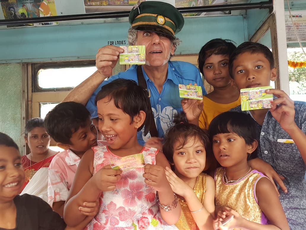 Roberto with a happy bunch of children from the Durga Puja Tramjatra in 2019