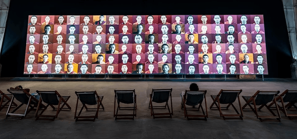 In a huge industrial shed on Willingdon Island, a short ferry ride away from most of KMB’s sites in Fort and Mattancherry, sits 79-year-old Serbian conceptual and performance artist Marina Abramović’s 18-metre-wide, multi-channel Waterfall installation, showing 108 Tibetan Buddhist monks and nuns chanting the Heart Sutra.