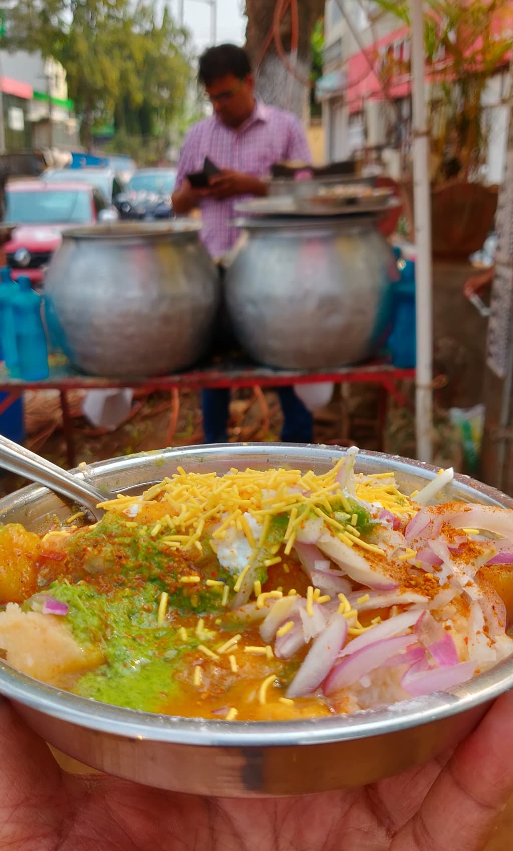A riot of colours, temperatures and textures in a single bowl, with a colourful garnish of onions, green chillies, coriander, spices and crispy sev.