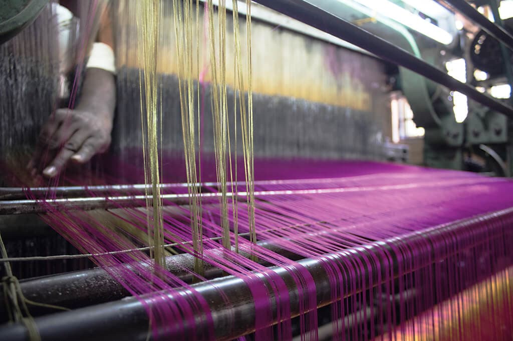 Weavers sing of the vadamalli flower as their skilled hands weave the colour into sarees in Kanchipuram