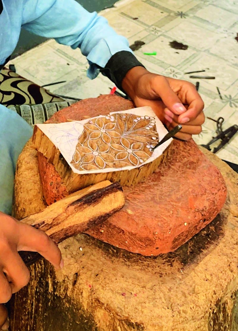 Wooden print blocks being hand-carved.