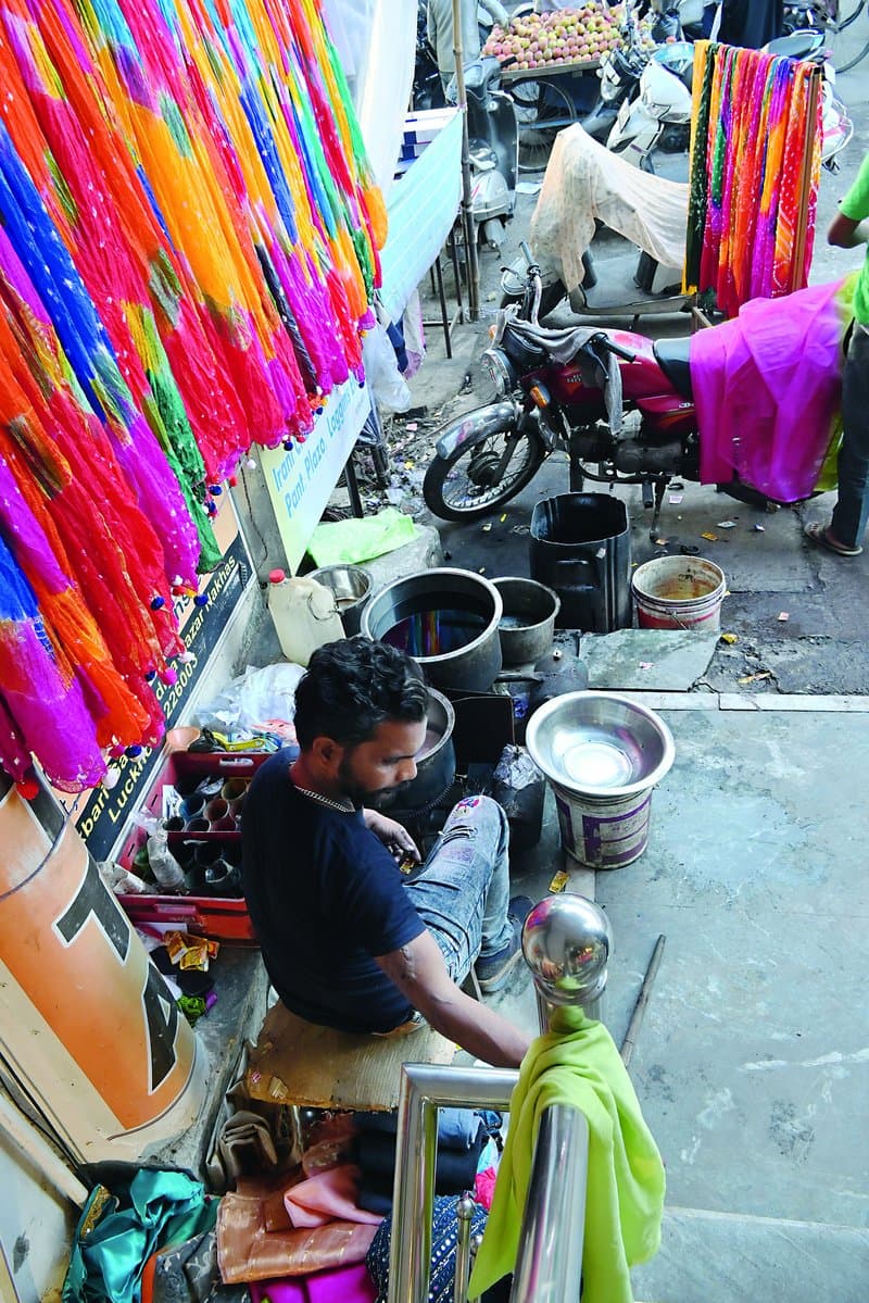 The rangrez (dyer) treats the fabric with colour