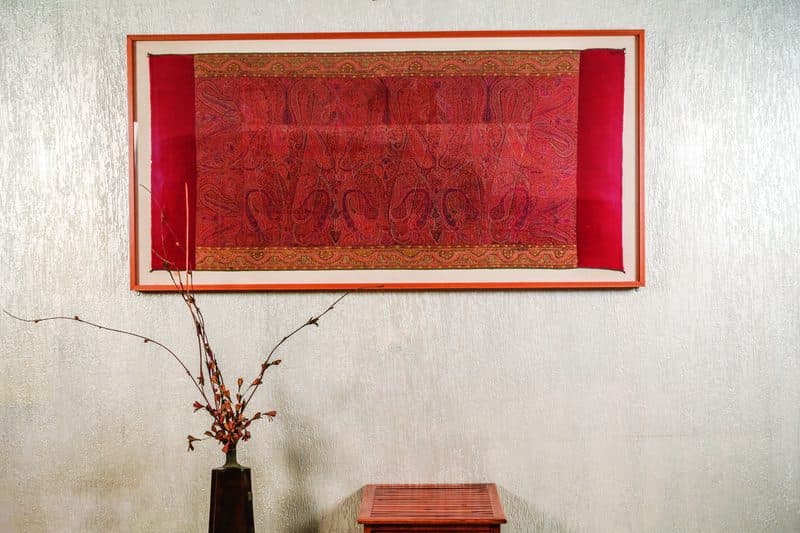 A framed antique Kani shawl belonging to his mother is displayed on the wall at Dr Sumaid Kaul’s Delhi home.