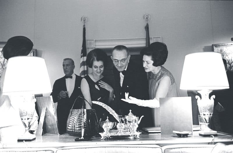 Prime Minister Indira Gandhi, President Lyndon B. Johnson and Lady Bird Johnson exchange gifts in the Yellow Oval Room at the White House on March 28, 1966.